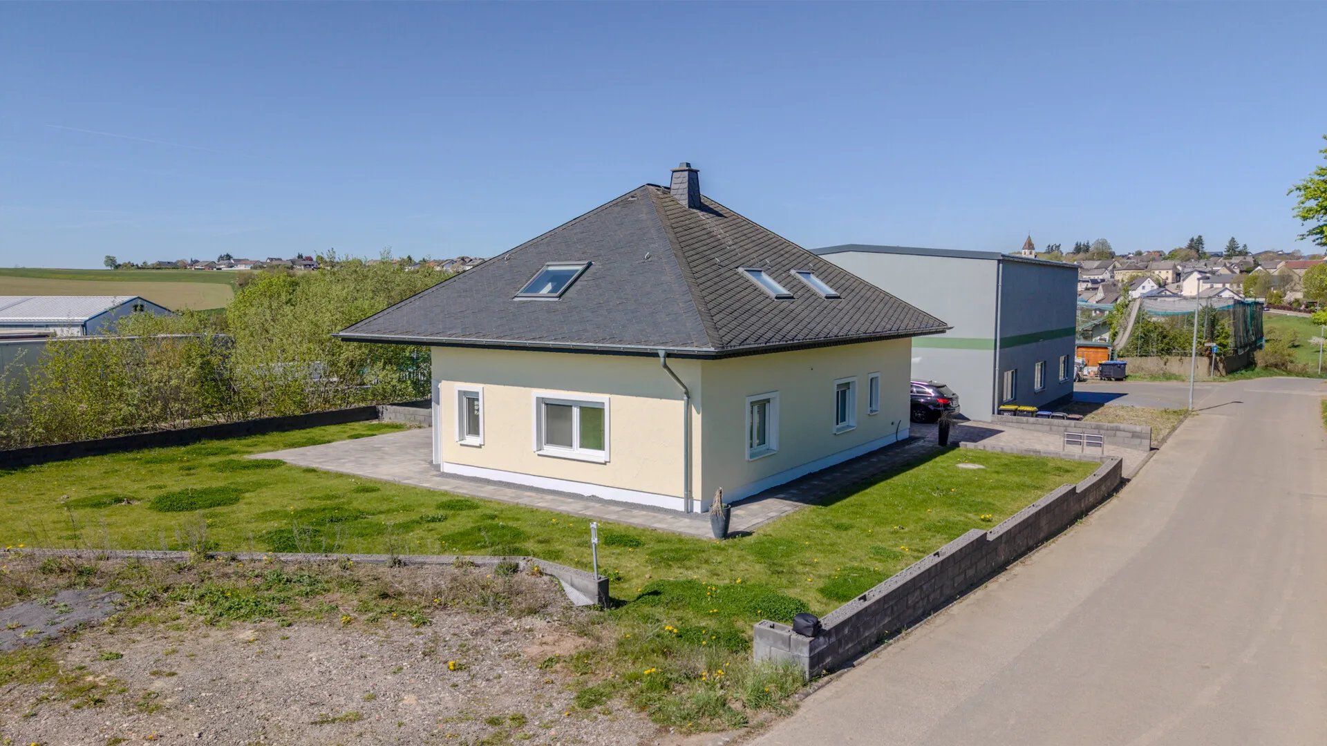 Neuwertiger Walmdachbungalow mit ELW (vermietet) &
sep. Gewerbehalle!